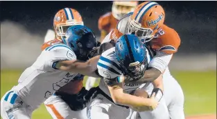 ?? BRAD HORRIGAN/HARTFORD COURANT ?? Bloomfield defensive lineman Kyle Barrow wraps up Plainville running back Beau Lasher in the semifinals of the CIAC Class S playoffs Monday at Bloomfield High School.