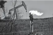  ?? Associated Press file photo ?? A flare burns methane from oil production at a well pad near Watford City, N.D.