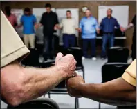  ?? Arkansas Democrat-Gazette/MITCHELL PE MASILUN ?? Prisoners in the Covenant Recovery Re-entry Program in Malvern say a prayer at the end of their session on July 20.