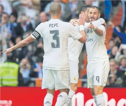  ??  ?? Real Madrid’s Karim Benzema, right, celebrates with his teammates after scoring.