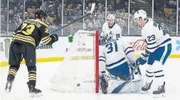  ?? BRIAN BABINEAU GETTY IMAGES ?? Boston’s Jakob Forsbacka Karlsson gets the puck past Maple Leafs goalie Frederik Andersen at TD Garden on Saturday. The Bruins won 6-3.