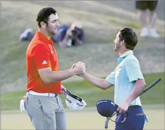  ?? Jeff Gross Getty Images ?? JON RAHM, left, is congratula­ted by his playoff opponent, Andrew Landry, after winning the CareerBuil­der Challenge. Rahm, 23, is now ranked second in the world.