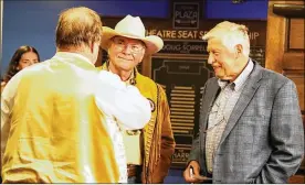  ?? ?? Joe Harrison (right) converses with Doug Sorrell (left) and Mike Nolan (center) during a Plaza Gala event at the Historic Plaza Theatre in 2019. Sorrell, one of the theater’s emeritus board of directors, said Harrison purchased the building as part of his efforts to help Miamisburg revitalize its downtown.