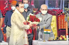  ?? PTI ?? Assam governor Jagdish Mukhi greets the new chief minister of Assam, Himanta Biswa Sarma, during his swearing-in ceremony in Guwahati on Monday.