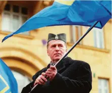  ?? Alexander Zemlianich­enko / Associated Press 1999 ?? Russian nationalis­t Vladimir Zhirinovsk­y, who led the Liberal Democratic Party, protests in a Serbian army cap in 1999.