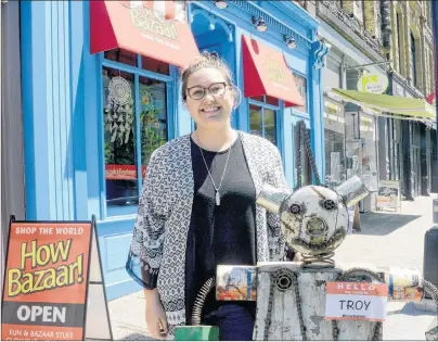  ?? MITCH MACDONALD/THE GUARDIAN ?? How Bazaar Halifax manager Avery Hillstrom stands outside the new Barrington Street location with the store’s mascot “Troy.” Hillstrom said the store has seen lots of traffic since opening earlier this spring.