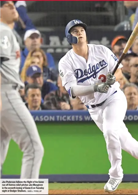  ?? | MARK J. TERRILL/ AP ?? Joc Pederson follows the flight of his home run off Astros relief pitcher Joe Musgrove in the seventh inning of Game 6 on Tuesday night at Dodger Stadium.