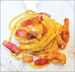  ?? AFP ?? The famed Italian pasta dish ‘spaghetti alla carbonara’ is served during a preview for the press to promote internatio­nal Carbonara Day in Rome.