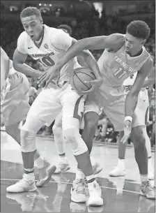  ?? Michael Woods / AP ?? Arkansas’ Daniel Gafford (left) and Tennessee’ Kyle Alexander fight for a rebound during the first half of Saturday’s game in Fayettevil­le, Ark.