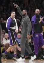  ?? MARK J. TERRILL — THE ASSOCIATED PRESS ?? Lakers forward LeBron James, center, celebrates along with Kyle Kuzma, left, and Tyson Chandler during the second half against the Detroit Pistons on Wednesday in Los Angeles.