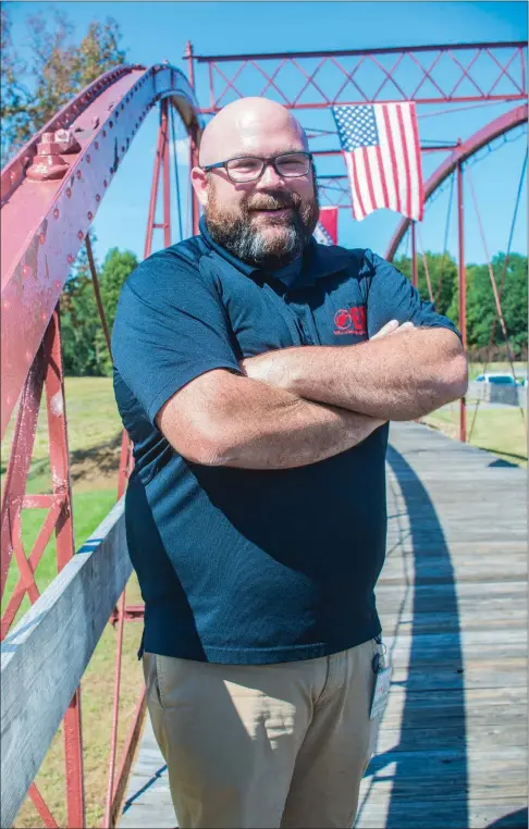  ?? WILLIAM HARVEY/RIVER VALLEY & OZARK EDITION ?? Jeff Gilkey, director of the Yell County Office of Emergency Management, stands on a bridge next to Danville City Hall. Gilkey, 39, has been the office’s director since 2010, and he was a detention officer before then. Gilkey received a state award...