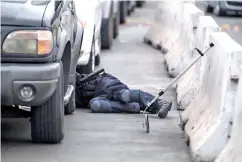  ??  ?? A US Customs and Border Protection officer, working in anti-terrorism contraband enforcemen­t, searches underneath a car in the pre-primary inspection area at the San Ysidro crossing in San Diego.