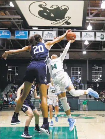  ?? Gerald Herbert / Associated Press ?? UConn forward Olivia Nelson-Ododa blocks a shot by Tulane guard Dynah Jones in the second half of Wednesday’s 75-33 victory on Wednesday in New Orleans.