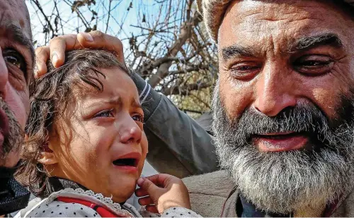  ?? ?? Daughter of Irfan Khan, a police officer, who along with other officers was killed, weeps during a protest by policemen on Wednesday to condemn the blast in a mosque in Peshawar . — afp