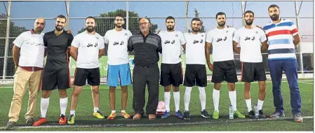  ?? — AFP ?? Home ground: The Aqal family before their match in a tournament pitting the largest Palestinia­n families from Jerusalem against each other in the Old City.