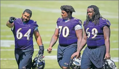  ?? (File Photo/AP/Patrick Semansky) ?? Baltimore Ravens guard John Urschel (left) speaks with teammates Robert Myers (70) and Leon Brown as they walk off the field after NFL football training camp in Owings Mills, Md., in August 2015.