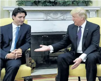  ?? SEAN KILPATRICK/THE CANADIAN PRESS ?? Prime Minister Justin Trudeau meets with U.S. President Donald Trump in Washington, D.C., on Monday. Despite this moment before the two shook hands, a joint statement on shared priorities seemed to suggest the first-in-person encounters between the...