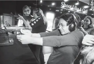  ?? Michael Ciaglo / Houston Chronicle ?? Josie Lopez is walked through gun handling and safety procedures at the Shoot Like a Girl trailer Saturday in League City. The trailer also featured long guns and compound bows.