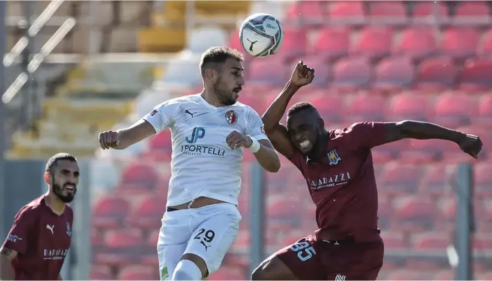  ??  ?? Hamrun's Serbian striker Predrag Dordevic (L) clears his lines ahead of Camerounis­e Raphael Sohna Kooh of Gzira. Copyright © Domenic Aquilina