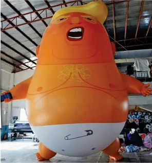  ??  ?? Crying shame: The 19ft balloon depicts Mr Trump as an angry baby
