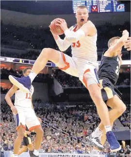  ?? MICHAEL CONROY/ASSOCIATED PRESS ?? Virginia’s Jack Salt grabs a rebound with attitude during the second half. The Cavaliers have won a regional final for the first time in a decade.
