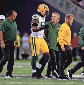  ?? KIRBY LEE / USA TODAY SPORTS ?? Green Bay Packers linebacker Rashan Gary leaves the field after suffering an injury during the first half Thursday against the Oakland Raiders at Investors Group Field in Winnipeg, Manitoba.