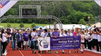  ?? MARIAN DENNIS — DIGITAL FIRST MEDIA ?? Relay walkers took the first lap as celebrator­y confetti was released behind them. The lap kicked off the 24hour Relay for Life Pottstown which returned for its 20th year on Saturday.