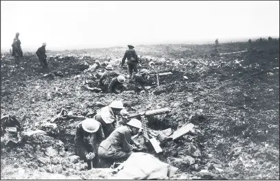  ??  ?? World War One Canadian troops sit in their fox holes manning their machine guns