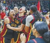  ?? Associated Press ?? USC’s Kayla Williams (left) and Kayla Padilla (second from left) celebrate after defeating Stanford in the Pac-12 tournament championsh­ip game on Sunday in Las Vegas.