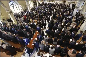  ?? (AP/Detroit News/Todd McInturf) ?? Family members, friends and supporters stand as the coffin is processed after the funeral Mass for Brian Fraser on Saturday at St. Paul on the Lake Catholic Church in Grosse Pointe Farms, Mich.