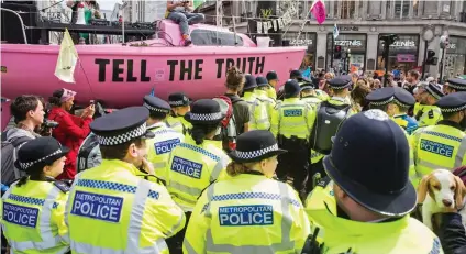  ??  ?? At last: Officers move in to arrest some of the protesters camped in Oxford Circus yesterday