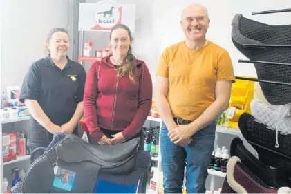  ?? Photo / Alyssa Smith ?? Emily Perrin (centre) receives her new saddle from Equestrian Country owners Kim and John Howarth.