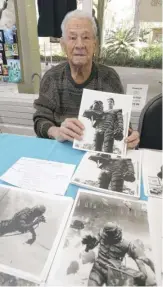  ?? BRUCE ACKERMAN/OCALA STAR-BANNER VIA AP ?? Ricou Browning holds photos during a 2018 festival in Silver Springs, Fla. He did stunt work on various films, including for Jerry Lewis.