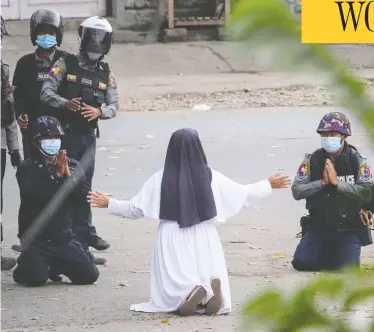  ?? HANDOUT / MYITKYINA NEWS JOURNAL / AFP VIA GETTY IMAGES ?? Sister Ann Rose Nu Tawng pleads with police not to harm protesters on Monday in Myitkyina, in Myanmar's Kachin state, amid a deadly crackdown on demonstrat­ions against last month's military coup.