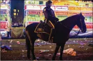  ?? MAX BECHERER / THE ADVOCATE ?? A New Orleans police officer works the scene where a man was hit and killed by a float in the run-up to Mardi Gras in New Orleans Saturday.