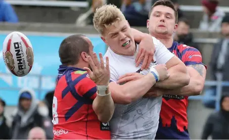  ?? STEVE RUSSELL/TORONTO STAR ?? The Wolfpack’s Dan Fleming loses the ball as two Oxford players converge on him. Toronto had its way with the visitors in the team’s home opener.