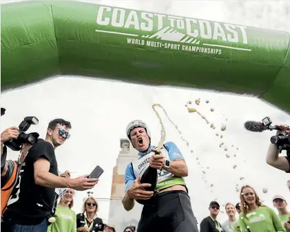  ?? GEORGE HEARD/STUFF ?? Sam Clark celebrates winning the Coast to Coast at New Brighton in Christchur­ch yesterday.