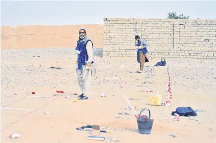  ?? ?? Deminers working in Nad-e-Ali village