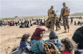  ?? BULENT KILIC / AFP / GETTY IMAGES ?? Civilians evacuated from ISIL’S embattled holdout of Baghouz wait at a screening area held by the U.s.-backed Kurdish-led Syrian Democratic Forces on Tuesday.