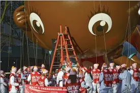  ?? ANDREW SENG / THE NEW YORK TIMES ?? Crews inspect the Ada Twist balloon Thursday before the start of the Macy’s Thanksgivi­ng Day Parade in New York.