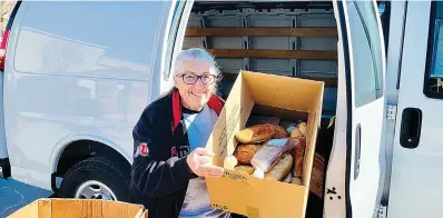  ?? (Photo by Kate Nielsen) ?? Shauna Devenport, a.k.a. the "Bread Lady," unloads her van at her Salt Lake City home in February.