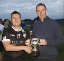  ??  ?? Newtown captain Dean Odlum collects the Division 2 cup from Wicklow County Chairman Martin Fitzgerald.