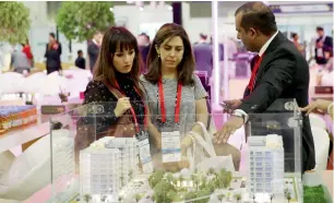  ??  ?? Visitors check out properties at the pavilion of Danube properties during Cityscape Global 2018.