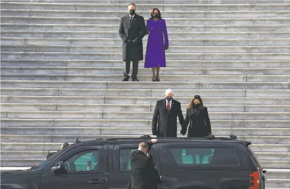  ?? Yalonda M. James / The Chronicle ?? Second gentleman Doug Emhoff and Vice President Kamala Harris watch former Vice President Mike Pence and his wife, Karen, depart on Inaugurati­on Day.