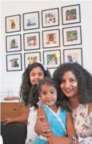  ?? DOUG HOKE/THE OKLAHOMAN ?? Angela Oommen, a native of Kerala, India, sits with her two children, Annebelle, 9, and Emily, 4, in front of a wall of family photos in her Oklahoma City home.