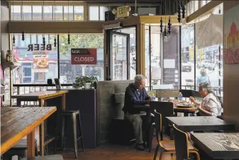  ?? Photos by Brontë Wittpenn / The Chroniclex­0 ?? John Castro and his wife, Cindy, eat lunch Monday at Kasa Indian Eatery on Polk Street in San Francisco. Kasa’s owner and her landlord are negotiatin­g a new lease for the location.