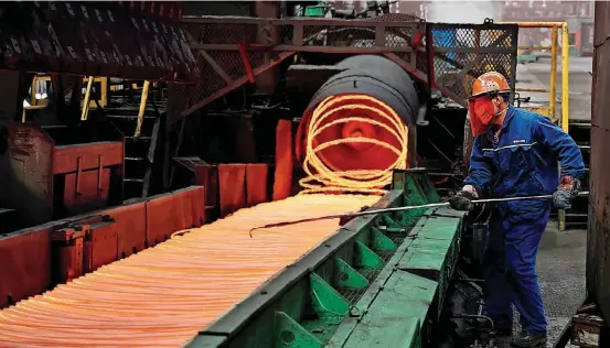  ??  ?? A worker manipulate­s coils of steel at Xiwang Special Steel in Zouping County in eastern China’s Shandong province. The S&P 500 plunged 1.1 percent the day President Donald Trump first mentioned the possibilit­y of steel and aluminum tariffs to industry...