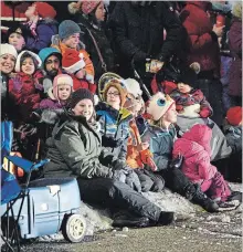  ??  ?? A large crowd of children and parents lined up in the cold along Hespeler Road for a chance to see Santa Claus.