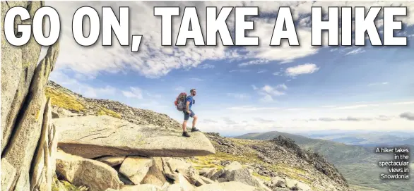  ??  ?? A hiker takes in the spectacula­r views in Snowdonia