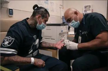  ?? PABLO UNZUETA FOR CALMATTERS ?? California’s new Office of Health Care Affordabil­ity is charged with capping price increases for consumers. It set a preliminar­y goal of limiting increases to 3% a year. Here, Dr. Oscar Casillas removes a pair of stitches from Alex’s hand at Martin Luther King Jr. Community Hospital on July 26, 2022.